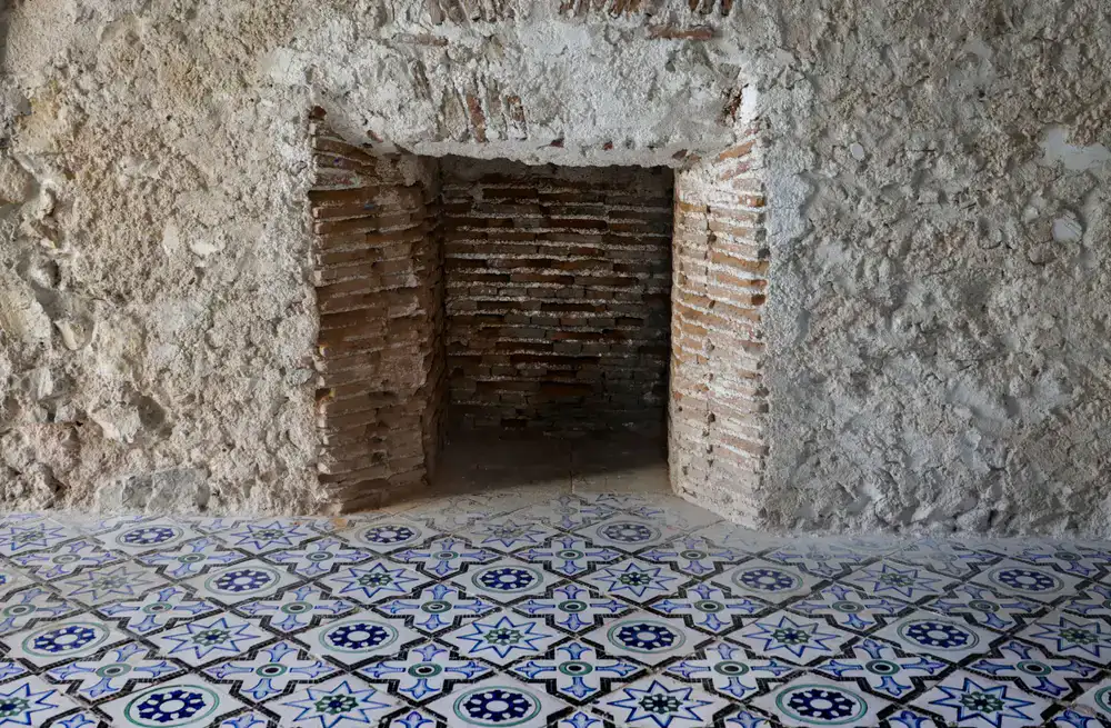 Classic blue and white patterned tile wall in a sunlit room
